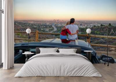 Couple watching sunset from popular view point in Los Angeles Wall mural