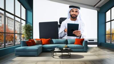 Emirate middle-eastern businessman wearing kandora working in the office, Dubai Wall mural