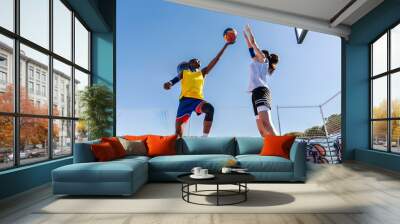 Female basketball players training at city basketball court Wall mural