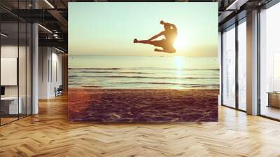 flying kick on the beach Wall mural