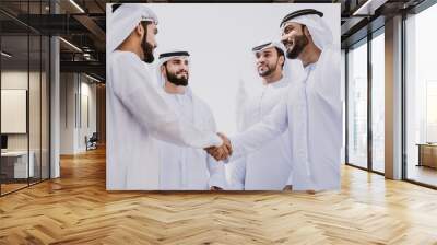 Group of businessmen talking on the street in Dubai Wall mural