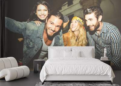 Group of friends sitting on the stairs and taking selfie Wall mural