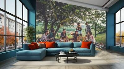 Group of friends spending time making a picnic and a barbeque Wall mural