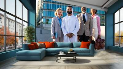 Group of multiethnic business people meeting an emirati businessman - International corporate business team bonding outdoors in the city Wall mural