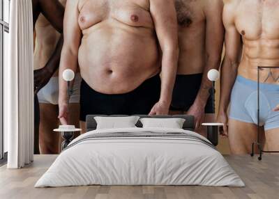 group of multiethnic men posing for a male edition body positive beauty set. Shirtless guys with different age, and body wearing boxers underwear Wall mural