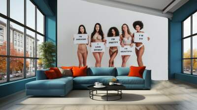 Group of women with different body and ethnicity posing together to show the woman power and strength. Curvy and skinny kind of female body concept Wall mural