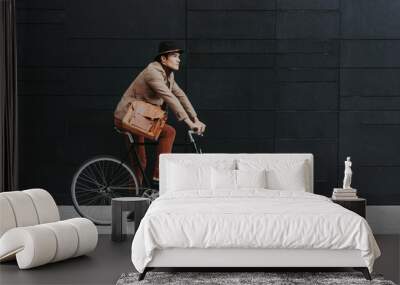 Handsome young business man with his modern bicycle. Wall mural