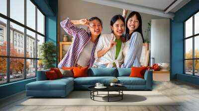 Happy beautiful chinese women friends bonding at home Wall mural