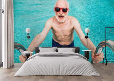 Happy senior man at the swimming pool Wall mural