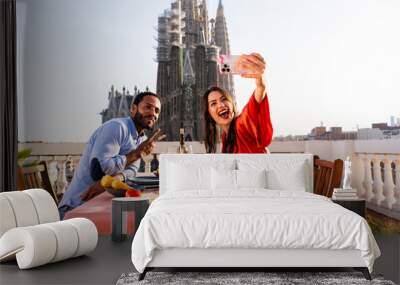 Multiracial beautiful happy couple of lovers dating on rooftop balcony at Sagrada Familia, Barcelona - Multiethnic people having romantic aperitif dinner on a terrace with city view  Wall mural