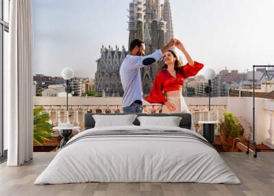 Multiracial beautiful happy couple of lovers dating on rooftop balcony at Sagrada Familia, Barcelona - Multiethnic people having romantic aperitif dinner on a terrace with city view  Wall mural