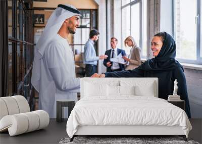 Multiracial group of corporate businesspeople working in a business office - Multiethnic businessmen and businesswomen meeting in the office in Dubai, UAE Wall mural