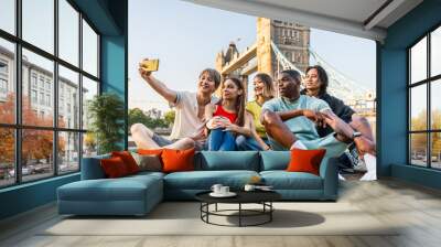 Multiracial group of happy young friends bonding in London city - Multiethnic teens students meeting and having fun in Tower Bridge area, UK - Concepts about youth lifestyle, travel and tourism Wall mural