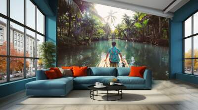 Palm tree jungle in the philippines. concept about wanderlust tropical travels. swinging on the river. People having fun Wall mural