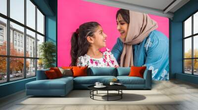 Portrait of middle eastern mother and daughter wearing traditional abaya Wall mural