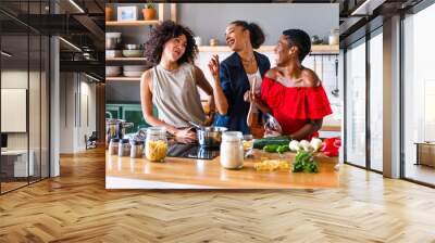 Three mixed race hispanic and black women bonding at home - Multiracial group of happy young female adults spending time together and having fun Wall mural