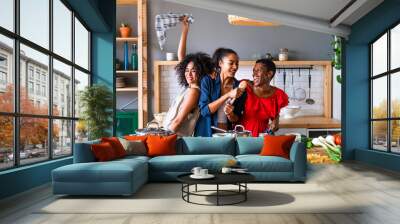 Three mixed race hispanic and black women bonding at home - Multiracial group of happy young female adults spending time together and having fun Wall mural