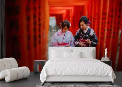 Two japanese girls wearing kimonos traditional clothes, lifestyle moments Wall mural