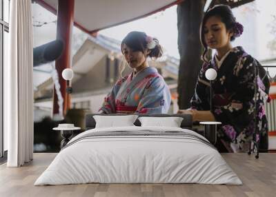 Two japanese girls wearing kimonos traditional clothes, lifestyle moments Wall mural