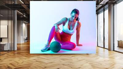 Woman training with the exercizes ball in the gym Wall mural