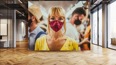 Woman wearing mask travelling in the subway during covid-19 pandemic Wall mural