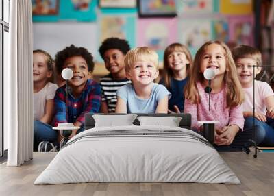 Group Of Pre School Children Answering Question In Classroom Wall mural