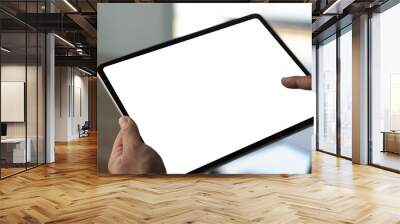 A businessman holds a mockup. iPad digital tablet with blank screen Mockup replaces your design mockup in the office. Wall mural