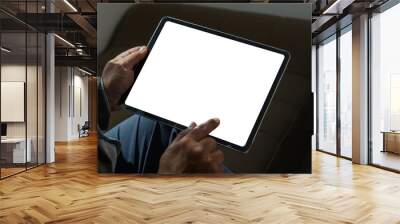 A businessman holds a mockup. iPad digital tablet with blank screen Mockup replaces your design mockup in the office. Wall mural