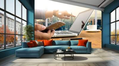 man hand holding smartphone device and  technology , businessman working with modern devices, digital tablet computer and mobile phone. Wall mural