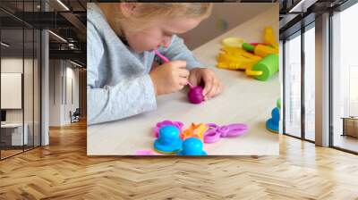 3 years girl creative arts. Child hands playing with colorful clay plasticine. Self-isolation Covid-19, online education, homeschooling. Toddler girl studying at home, home learning Wall mural