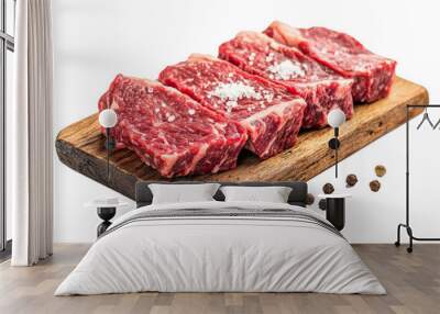 marbled beef steak cuts on a wooden board, with a sprinkle of sea salt and cracked pepper. Wall mural