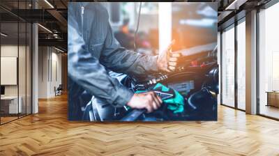 technician working on checking and service car in  workshop garage; technician repair and maintenance engine of automobile in car service. Wall mural