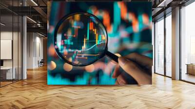 Analyzing Market Trends: Hand Holding Magnifying Glass Over Financial Chart. Wall mural