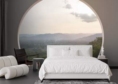 A wall with arch shape gap looking out over the mountains 3d render,The room has black tile floor.Furnished with wood and leather chair.Looking out to the balcony and nature view. Wall mural