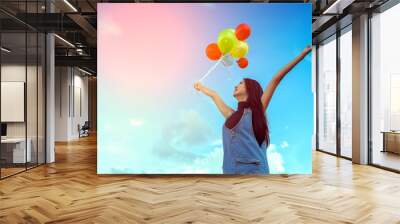 Vintage photo of young woman with colorful balloons Wall mural