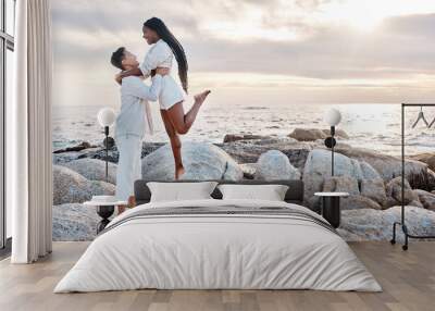 A young mixed race couple enjoying a day at the beach looking happy and in love. A young mixed race couple enjoying a day at the beach looking happy and in love. Wall mural