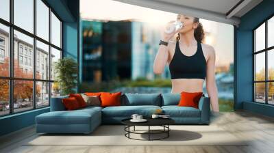 Fitness, woman and drinking water in city for wellness or body health after exercise. Bottle, sports and thirsty person outdoor with refreshment, nutrition or diet for hydration with natural liquid Wall mural