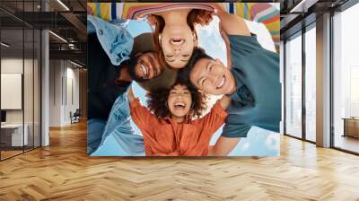 Friends, huddle and portrait in outdoor hug, solidarity and low angle for love on blue sky. People, social diversity and embrace for support or reunion, together and youth culture for motivation Wall mural