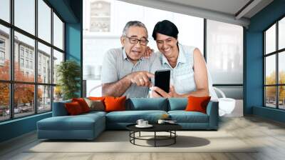 Happy, home and senior couple with a smartphone, connection and network with social media, mobile app or communication. Spouse, mature man or elderly woman with a cellphone, happiness or website info Wall mural