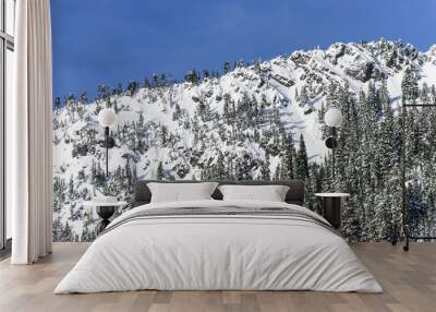 Blue Sky Above Snowy Cliffs on Mountain Ridge Wall mural