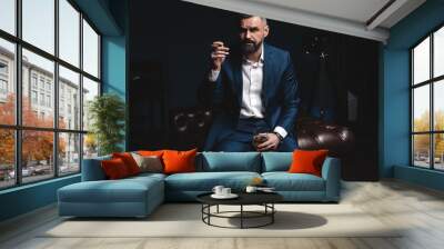 Attractive man with cigar and a glass whiskey Wall mural