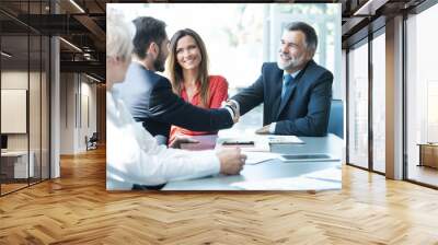 Business people shaking hands, finishing up a meeting. Wall mural