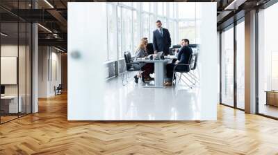 Businesspeople discussing together in conference room during meeting at office. Wall mural