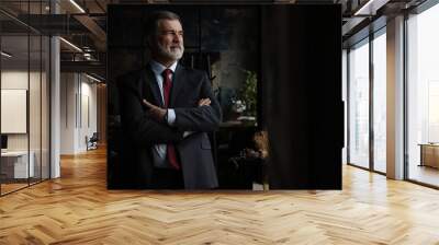 Confident mature business man with arms crossed looking at camera, smiling standing in modern office Wall mural