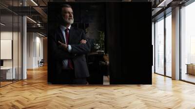 Confident mature business man with arms crossed looking at camera, smiling standing in modern office Wall mural