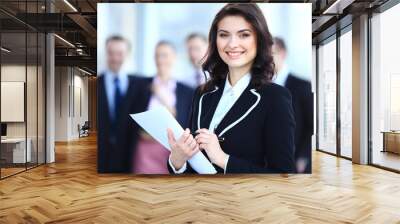 Face of beautiful woman on the background of business people  Wall mural