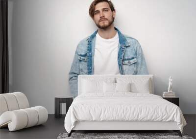 Fashion portrait of young man wearing jeans jacket Wall mural