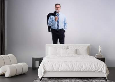 Full length portrait of confident mature businessman in formals standing isolated over white background. Wall mural