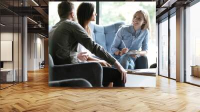 Group of young modern people in smart casual wear discussing business while working in the creative office Wall mural