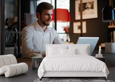 Handsome businessman working with laptop in office Wall mural